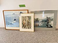Three framed artworks side by side showing relative sizes and frame finishes