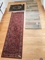 Three rugs laid out on floor showing size comparison and patterns