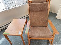 Armchair and side table side-by-side showing overall design, fabric and wood finish