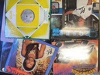 Stack of four visible records including generic Disco 45 sleeve and Caribbean releases