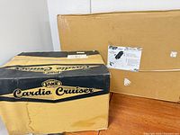Both sealed cartons: Hang Ups F7000 inversion table and Body by Jake Cardio Cruiser.