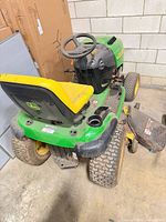 Rear and side view showing seat, rear tires, cup holder and deck