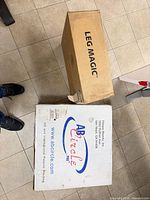 Leg Magic and Ab Circle Pro boxes side by side