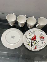 Set showing four mugs and four plates tops and undersides