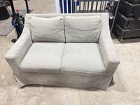 Front view of light gray loveseat with two seat and back cushions