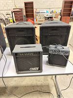 Four amplifiers/cabinets on table