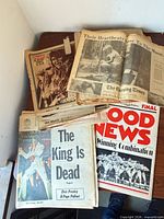 Stack of vintage newspaper sections and pullouts on table