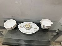 Group shot of bowls, platter with lidded bowl, and nested casseroles
