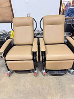 Front view of both matching tan medical recliners