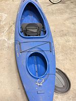 Full view of blue sit-in kayak showing cockpit, seat, rear hatch cover attached