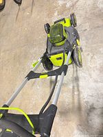 Top view of Sun Joe cordless lawn mower with handle extended