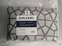 Curtain panel in sealed plastic packaging showing folded fabric and label