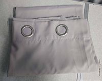 Folded curtain panel showing two metal grommets