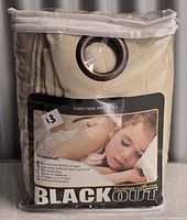 Front of sealed package showing product label and curtains inside