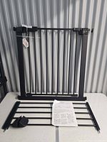 Gate frame, extension panel, hardware cover and instructions displayed