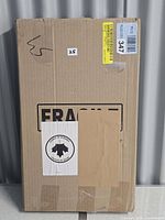 Sealed shipping box with fragile labels containing the canvas print