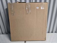 Sealed cardboard box containing the canvas print