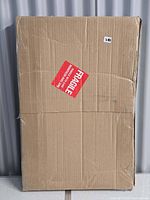 Cardboard shipping carton with fragile sticker containing new canvas set