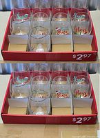Retail display tray holding 12 of the stemless wine glasses with assorted holiday prints