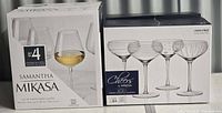 Boxes of Mikasa Samantha white wine glasses and Cheers coupe cocktail glasses