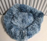 overall view of blue shag doughnut pet bed