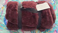 Rolled wine faux fur throw with tag and strap