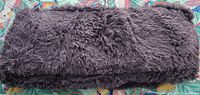 Folded dark gray shag rug overall view