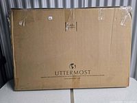 Sealed shipping box labeled Uttermost containing mirror