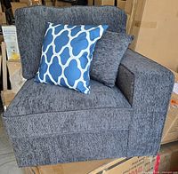 Front view of dark grey right arm sofa chair with blue patterned pillow