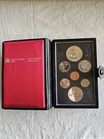 Closed presentation case showing red interior panel with Royal Canadian Mint logo and window revealing proof coins