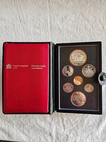 Closed display case showing red Royal Canadian Mint cover and open view of coin holder