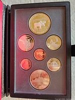 Open display showing all seven proof coins in holder
