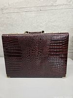 Front exterior of brown alligator-pattern attaché case