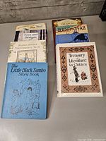 Group of children’s hardcover books in two stacks showing titles