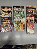 Three columns of cookbooks and magazines on table