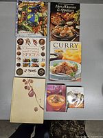 Seven cookbooks laid out showing front covers