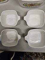 Four plain white petite individual casseroles
