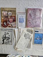 All six craft booklets and charts laid out on surface