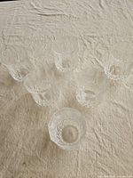 All six clear crystal tumblers arranged top view to show quantity and faceted bases