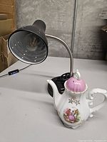 Desk lamp and porcelain music box coffee pot together
