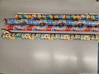 Four rolls of themed wrapping paper laid out