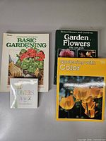 Four gardening books laid out: Complete Guide to Basic Gardening, Garden Flowers You Can Grow, Gardening with Color, Flowers A to Z