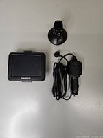 GPS unit, mount, and charger laid out
