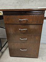 Front view showing four drawers and hardware