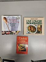 Three cookbooks laid out showing full covers