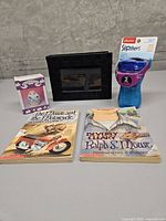 Group shot showing both Beverly Cleary books, packaged Playtex sippy cup, boxed bunny candle, and black photo album