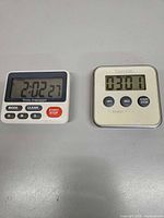 Front view of both digital kitchen timers on surface