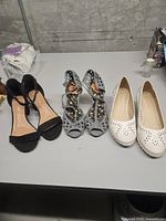 All three pairs of shoes on table