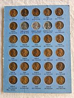 Full view of Whitman coin board showing 30 openings with 27 pennies in place