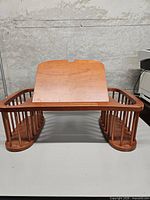 Front view showing entire mahogany lap desk, tilt panel up, side spindle baskets visible